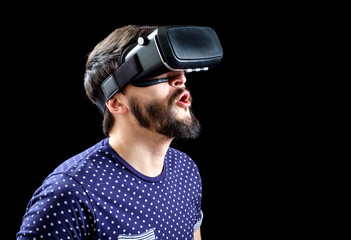 Man in blue dotted T-shirt wearing virtual reality 3d-headset