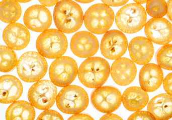 Bright sweet kumquat slices on white