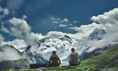 hikers on the trail in the Apls mountains. Trek near Matterhorn mount. Mountain ridge on the...