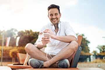 Young man listening to music on a smart phone