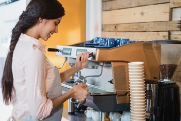 Waitress using coffeemaker
