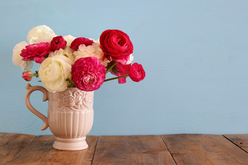 Bouquet of pink and white rosses in the vintage white vase