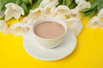 Coffee cup and white flower bouquet