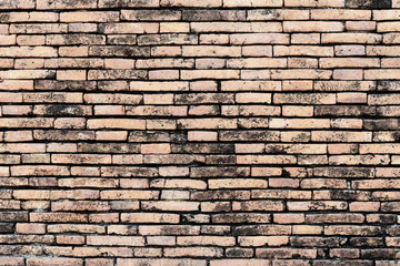 Obraz premium Old brick wall,different sized and red, orange and yellow make irregular brickwork pattern.Vintage texture background.Old construction and building background. Retro backdrop with free space for text.