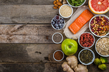 Selection of superfoods on rustic background