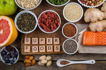Selection of superfoods on rustic background