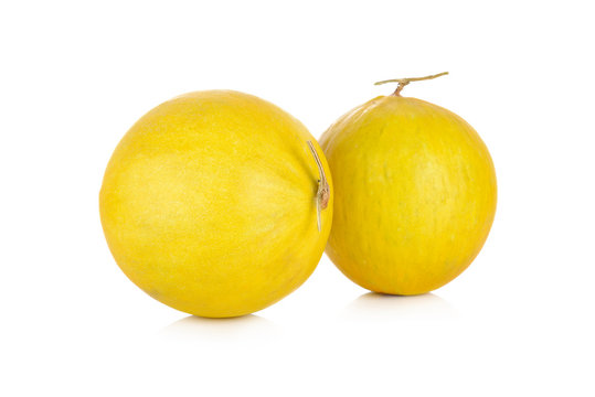 whole fresh yellow melon with stem on white background