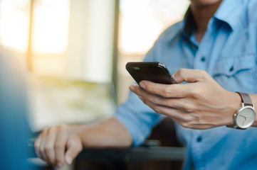 man in casual form using mobile phone at modern office