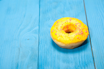 Doughnut on blue wooden table