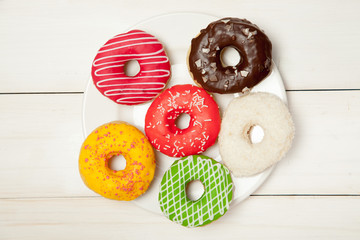 Doughnuts on a white wooden table