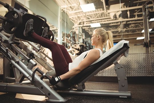 Fit woman exercising on a machine