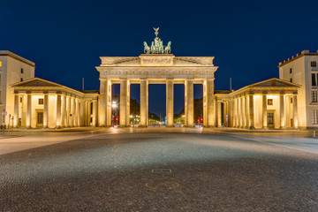 The famous Brandenburg Gate in Berlin illuminated at darkness © elxeneize