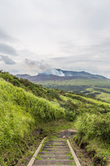 Fototapeta na wymiar Erupting Mount Aso volcano view from natural trail in Kumamoto, Kyushu, Japan