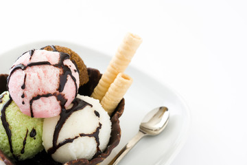 Ice cream scoops served in waffle basket isolated on white background
