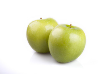 Two green apples on a white surface. Apples isolated on white background.