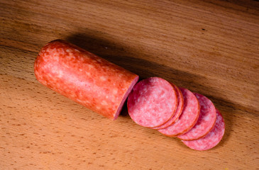 Sliced salami sausage on cutting board