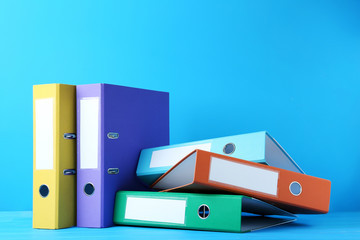 Colorful office folders on blue background