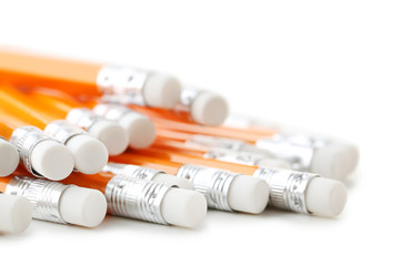 Yellow pencils with erasers on a white background