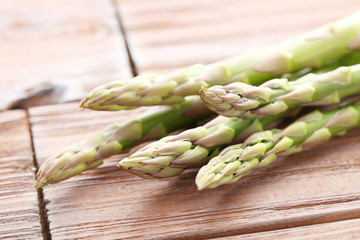 Green asparagus on brown wooden table