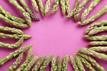 Green asparagus on the pink background