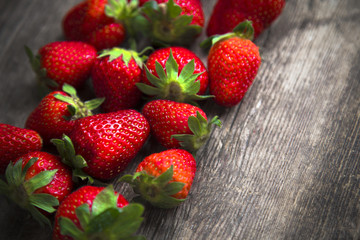 fresh strawberries on old wooden background