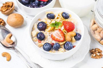 crunchy flakes with blueberries and various yogurts for healthy breakfast, close-up