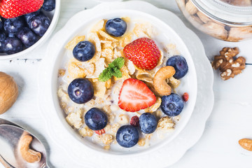 crunchy flakes with blueberries and various yogurts for healthy breakfast, close-up