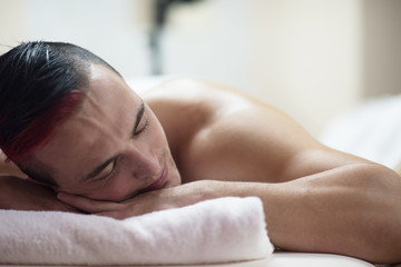 handsome man resting in a spa massage center