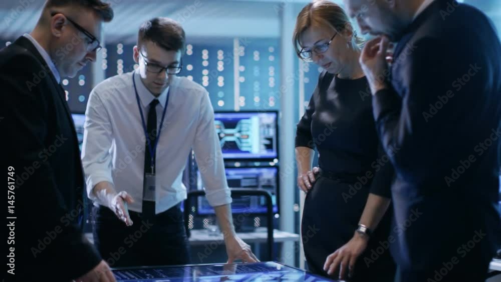Aufkleber Team of Government Agents Tracking Fugitive with Help of Touchscreen Interactive Table in Big Monitoring Room Full of Computers with Animated Screens.Shot on RED EPIC-W 8K Helium Cinema Camera.