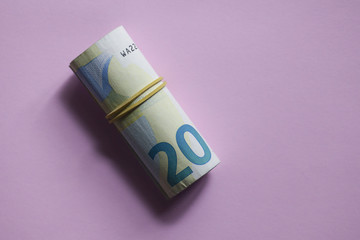 20 Euro roll on a pink background.