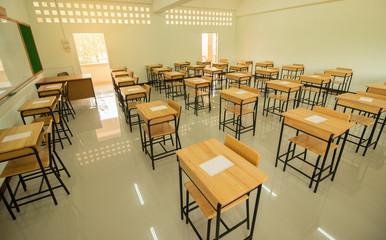 School classroom with test exam paper on desks chair wood, and blackboard at high school thailand, education concept