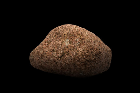 Granite stone red color isolated on black background. Very similar to the planet Mars or the stone of the red planet