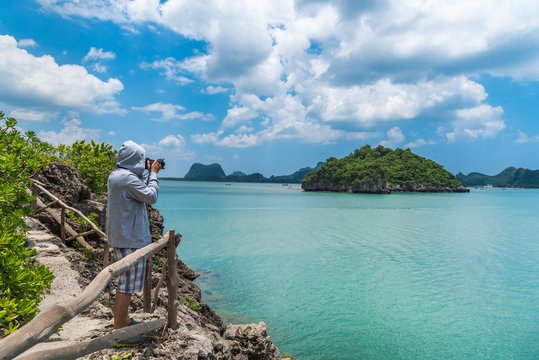Photographer take photo landscape of beautifu island with sea in blue sky, Thailand.