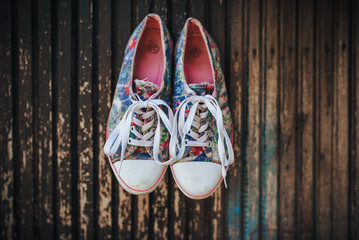 Colored women's sneakers on a wooden background.