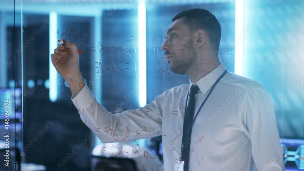 Aufkleber in system control center chief engineer writes with red marker on a glass board. in the background m