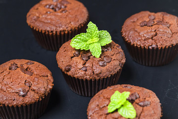 chocolate muffin with mint on a wooden table