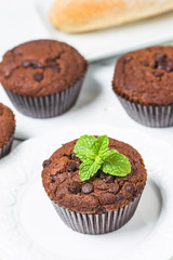 chocolate muffin with mint on a wooden table