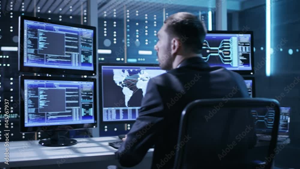Poster Technical Controller/ Operator Working Between Workstations with Multiple Displays. Possible Power Plant/ Airport Dispatcher/ Dam Worker/ Government Surveillance/ Space Program
