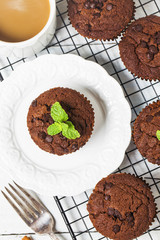 chocolate muffin with mint on a wooden table