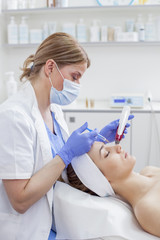 Young beautiful woman in the beauty salon on the face treatment