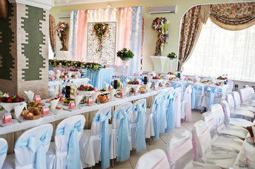 Vase with flowers at wedding tables set.