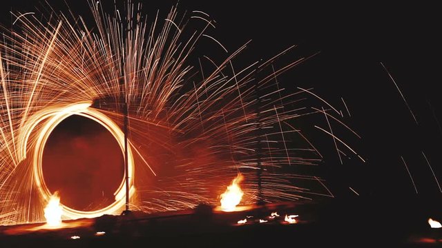 Beautiful fire show at night on the beach in Phuket, Thailand
