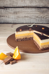 Orange chocolate cake with layers of delicate souffle, homemade dessert