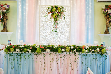 Decor with flowers on wedding table of newlyweds.