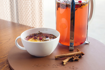Hot tea with cranberries and herbs in a French press