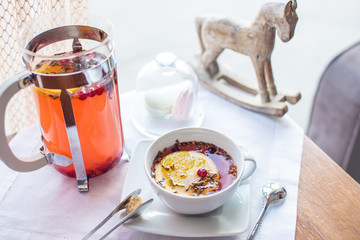 Hot tea with cranberries and herbs in a French press