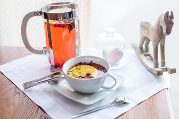 Hot tea with cranberries and herbs in a French press