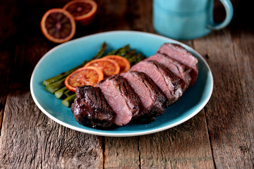 Duck breast baked in orange-honey sauce with asparagus. Rustic style.