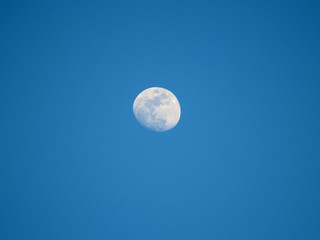Moon in the fourth quarter on a blue sky