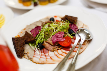 Delicious bruschetta with tomatoes on plate on table close-up Buffet table white plates